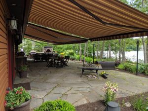 Striped Awning Over Stone Patio